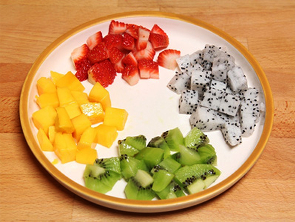 Prepare fruit & nut: Mangoes, bananas, apples, cashew are washed, peeled, and cut into dice.